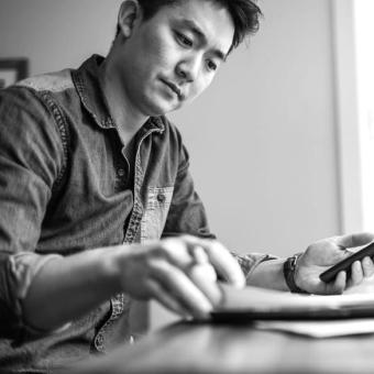 Man working at home on multiple devices